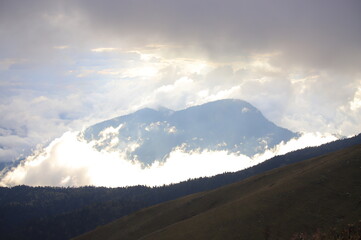 Mountains Shrouded in Clouds and Sunlight