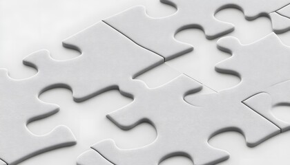 Close-up view of many light gray puzzle pieces.
