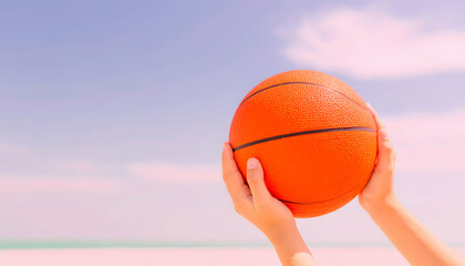 Close Up of Hands Holding Orange Basketball Against Blue Sky at Beach on Sunny Day
