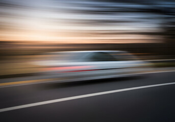Blurred car sunset road