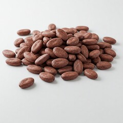 Obraz premium A scattered pile of raw cocoa beans on a white background, highlighting their individual textures and rich brown color.