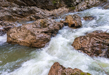 autumn hike to the sources of a mountain river along the riverbed and canyon through difficult wilderness areas