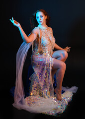 Fantasy studio portrait of a red-haired mermaid faery model wearing a white pearl gown, fairytale...
