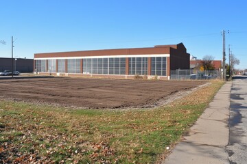 Cleared lot beside a large industrial building