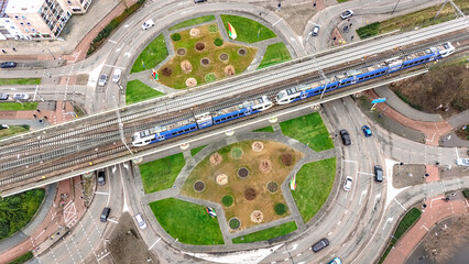 Road ring junction with motorway road and railway with train aerial drone view from above, urban transportation, Venlo, the Netherlands