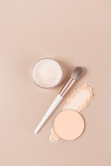 Beautiful Vertical Cosmetic Background With Two Kinds Of Dry And Compact Powder In Packages, Makeup Brush, Product Texture Sample. Top View.