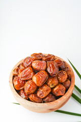 Dates fruit sukari or kurma sukari, in wooden bowl isolated on white background