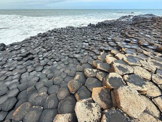 The Giant's Causeway, a UNESCO World Heritage Site on Northern Ireland's Antrim Coast, features 40,000 interlocking basalt columns formed by volcanic activity. Its hexagonal stones and coastal beauty 