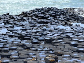 The Giant's Causeway, a UNESCO World Heritage Site on Northern Ireland's Antrim Coast, features 40,000 interlocking basalt columns formed by volcanic activity. Its hexagonal stones and coastal beauty 