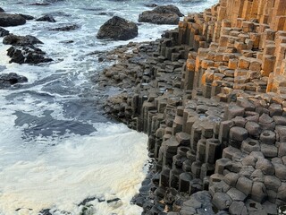 The Giant's Causeway, a UNESCO World Heritage Site on Northern Ireland's Antrim Coast, features 40,000 interlocking basalt columns formed by volcanic activity. Its hexagonal stones and coastal beauty 