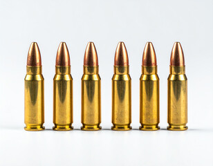 Six shiny brass bullets lined up, showcasing their metallic finish and pointed tips against a clean...