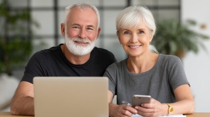 Obraz premium Senior Couple Using Laptop and Mobile Phone Together