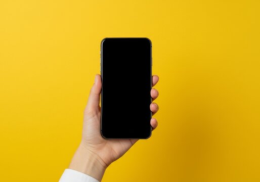Photo Hand Holds Blank Screen Smartphone on Yellow Backdrop