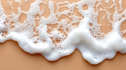 White foam wave on beige background