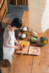 キッチンで料理をする50代女性