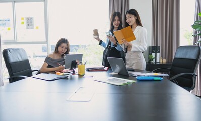 group of business people collaborating new project in office asian business woman team meeting discuss ideas Three female entrepreneurs.