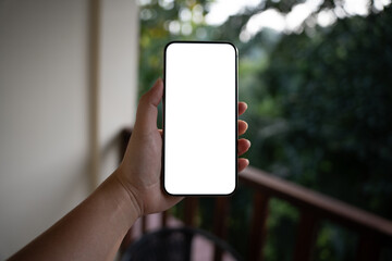 Smart phone mockup. Women hands holding cell telephone blank copy space screen smartphone blank white screen isolated technology concept.