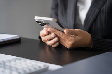 Asian Business woman using smart phone spending time checking news social media