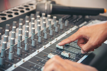 Production sound engineer woman hands adjusting volume equalizer voice, mixing console. DJ sound...