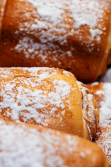 Close up of a delicious bun topped with powdered sugar