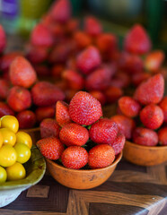 Fresh strawberries and cherry tomatoes in bowls