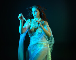 Fantasy studio portrait of a red-haired mermaid faery model wearing white pearl gown, fairytale...