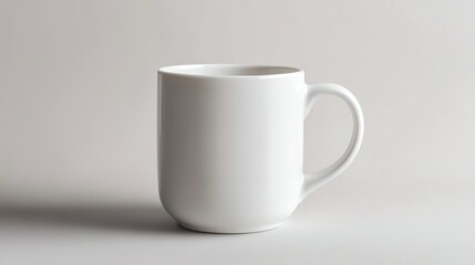 Obraz premium A light gray ceramic coffee mug sits isolated against a light gray background.