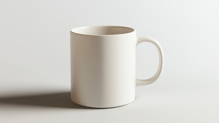 Fototapeta premium A light gray ceramic coffee mug is prominently displayed on a light gray background.