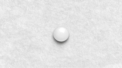 A white ball on a white surface.