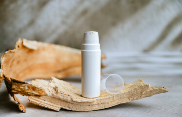 Face cream in a white  bottle on shadows background 