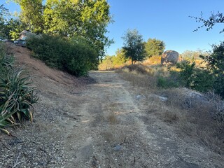 rough dirt road through the brush and bramble of the mountainous desert landscape - Escondido, California, USA