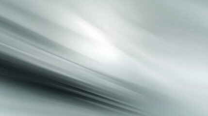 Grey abstract background featuring soft motion blur and subtle hues.
