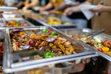 Buffet-style spread featuring assorted dishes and vibrant vegetables at a lively gathering