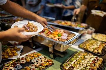 Delicious buffet spread featuring assorted dishes at a gathering with guests enjoying food