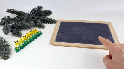 The word winter (winter solstice) is indicated on a school blackboard with a white background