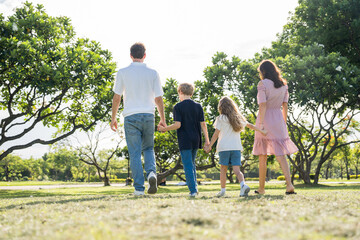 Fototapeta premium Happy family parent children having picnic outdoor activity. Enjoy happiness moment summer playing together including father mother son and daughter relaxing in the morning sunrise.