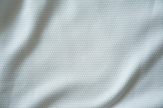 Close up of white football jersey sports clothing fabric texture.