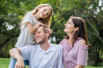 Fototapeta premium Happy family parent children having picnic outdoor activity. Enjoy happiness moment summer playing together including father mother son and daughter relaxing in the morning sunrise.