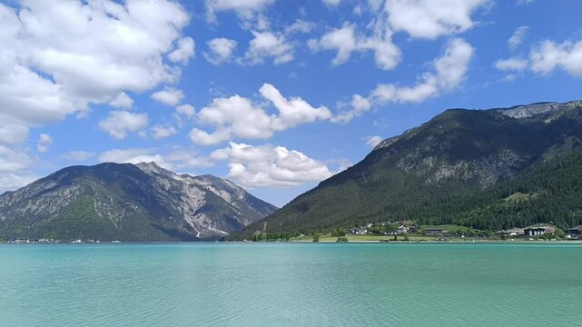 Explore the stunning Achensee in Tyrol, Austria, featuring breathtaking landscapes, serene waters, and majestic mountains under a vibrant sky