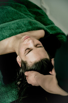 Young woman massagist making head massage