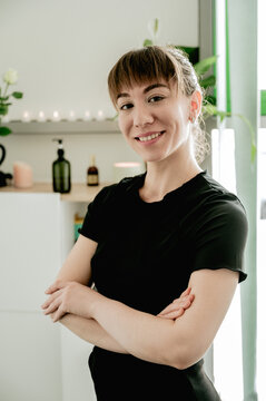 Young smiling woman massagist in her cabinet