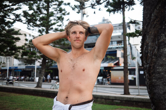 Shirtless man relaxing at Manly Beach, Sydney