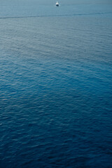 Fototapeta premium Lone boat crossing open sea near Pont d’en Gil, Menorca
