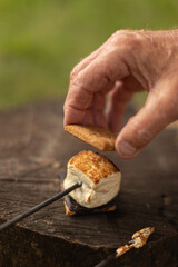 adding the top graham cracker to the smore