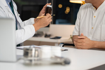 Male doctor consulting patient filling form at consultation, talking to patient filling signing medical paper at appointment visit in clinic.