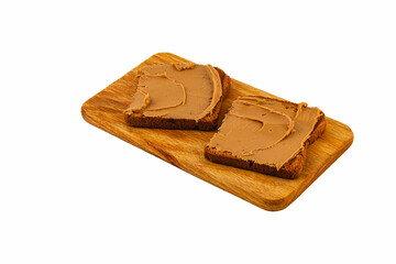 Sliced bread topped with chocolate spread on wooden board