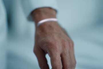 Fototapeta premium Hand wearing sleek wearable sensor for health monitoring