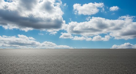 Obraz premium Asphalt Road Under Blue Sky With White Clouds Photo