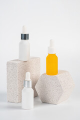 Plastic yellow tube for cream or lotion. Skin care or sunscreen cosmetic with stylish props on white background.