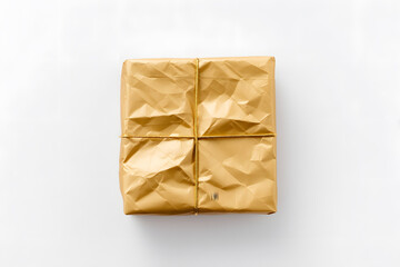 Present wrapped with gold tissue paper isolated on white background	

